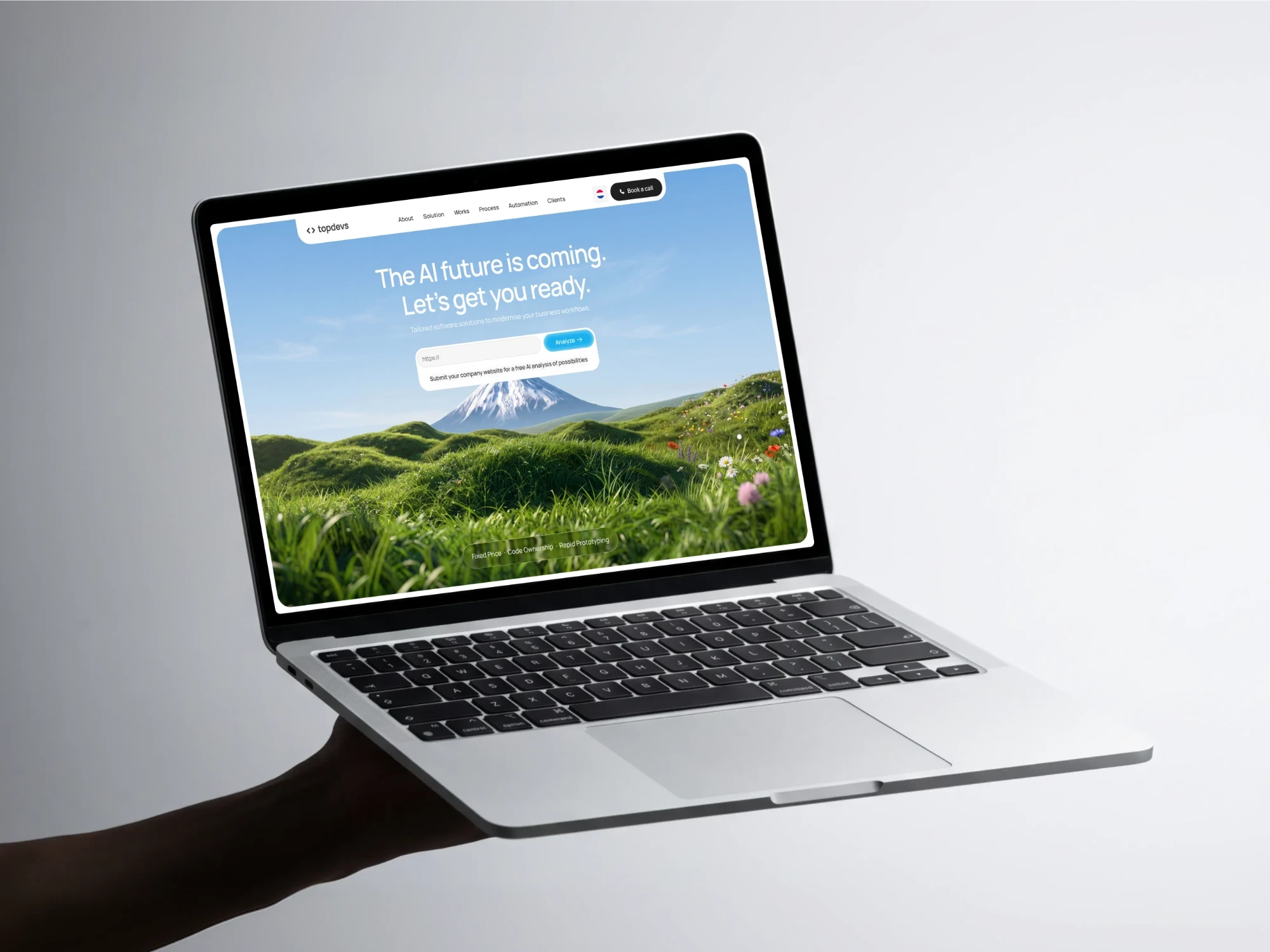 Topdevs website on a laptop held in one hand: The AI future is coming